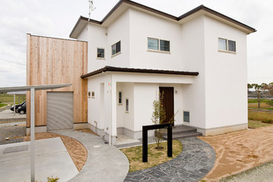 Photo of a modern two-storey stucco white exterior in Other with a shed roof and a metal roof.