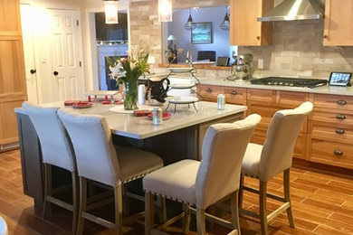 Inspiration for a transitional eat-in kitchen remodel in Boston with a farmhouse sink, quartz countertops and an island
