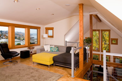 Photo of a large contemporary loft-style living room in Seattle with white walls and light hardwood floors.