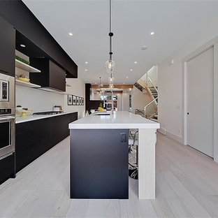 Свежая идея для дизайна: линейная кухня среднего размера в современном стиле с кладовкой, врезной раковиной, плоскими фасадами, черными фасадами, столешницей из оникса, фартуком из керамической плитки, техникой из нержавеющей стали, полом из терраццо, островом и белым полом - отличное фото интерьера