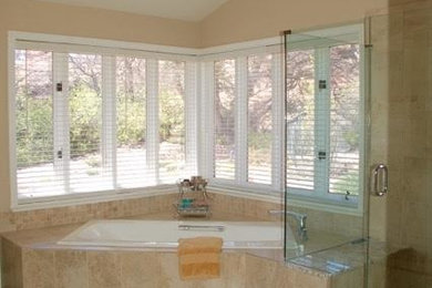Large elegant beige tile and ceramic tile double-sink drop-in bathtub photo in Denver with raised-panel cabinets, a built-in vanity, white cabinets, an undermount sink, granite countertops and a hinged shower door