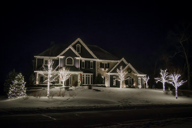 Example of a large classic gray two-story wood exterior home design in Other