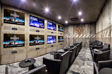 Home theater - mid-sized industrial enclosed carpeted home theater idea in Calgary with multicolored walls and a media wall