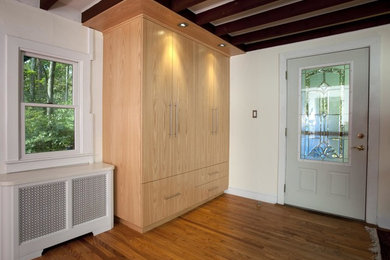 Reach-in closet - mid-sized modern gender-neutral medium tone wood floor and brown floor reach-in closet idea in Philadelphia with flat-panel cabinets and light wood cabinets