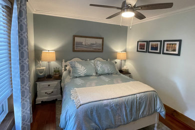 Inspiration for a small coastal guest dark wood floor bedroom remodel with green walls