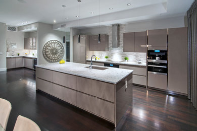 Photo of a large contemporary single-wall eat-in kitchen in Calgary with an undermount sink, flat-panel cabinets, beige cabinets, quartzite benchtops, multi-coloured splashback, matchstick tile splashback, stainless steel appliances, dark hardwood floors and with island.