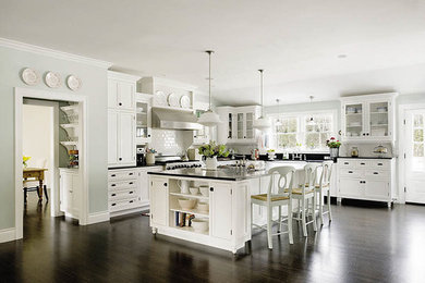 Enclosed kitchen - huge traditional l-shaped dark wood floor enclosed kitchen idea in Portland Maine with a farmhouse sink, beaded inset cabinets, white cabinets, granite countertops, white backsplash, subway tile backsplash, stainless steel appliances and an island