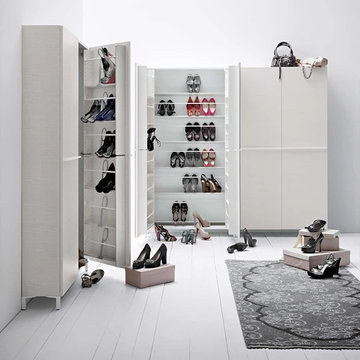 Linear white wooden shoe storage units by Birex