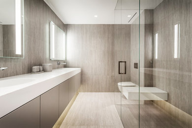 Large minimalist master porcelain tile porcelain tile and beige floor walk-in shower photo in New York with flat-panel cabinets, brown cabinets, a wall-mount toilet, beige walls, an integrated sink and a hinged shower door