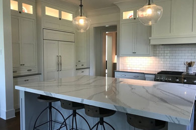 Kitchen - transitional medium tone wood floor kitchen idea in Other with a farmhouse sink, shaker cabinets, white cabinets, white backsplash and ceramic backsplash