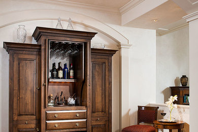 Mid-sized traditional single-wall wet bar in Other with raised-panel cabinets, dark wood cabinets and dark hardwood floors.