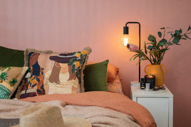 Mid-sized mediterranean master bedroom in Newcastle - Maitland with pink walls, dark hardwood floors and brown floor.