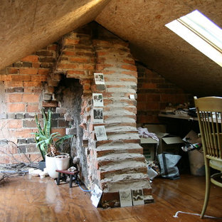 Inspiration for a small modern study in Melbourne with red walls, plywood flooring and a built-in desk.