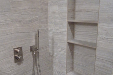 Example of a mid-sized trendy 3/4 brown tile and porcelain tile ceramic tile corner shower design in San Francisco with flat-panel cabinets, dark wood cabinets, a wall-mount toilet, white walls and a vessel sink