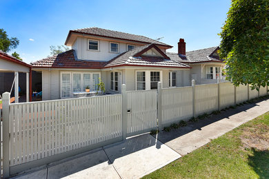 Arts and crafts two-storey grey exterior in Melbourne with wood siding and a gable roof.
