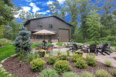 Rustic brown two-story metal exterior home idea in Minneapolis with a metal roof