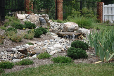 This is an example of a mid-sized traditional partial sun backyard water fountain landscape in Richmond for summer.