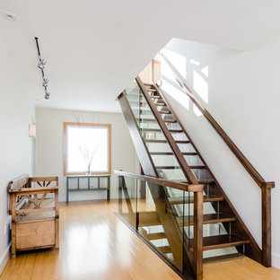 Large scandinavian wood straight wood railing staircase in Boston with glass risers.