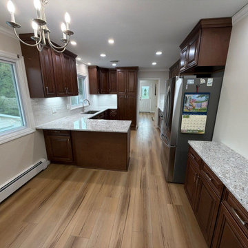 USCD cabinetry accompanied granite countertops, porcelain tile backsplash and Ca