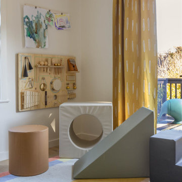 Kids’ Playroom with French Doors, Colorful Rug, and Activity Wall