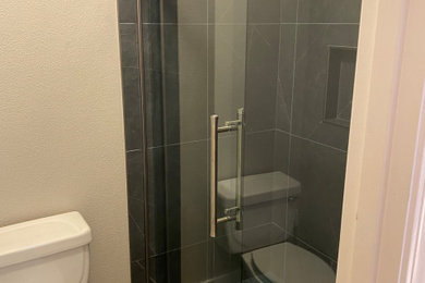 Example of a mid-sized trendy master black and white tile porcelain tile and blue floor bathroom design in Portland with a niche