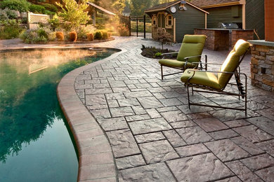 Mid-sized elegant backyard stamped concrete patio kitchen photo in Philadelphia with no cover