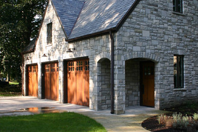 Garage - mid-sized traditional detached three-car garage idea in Other