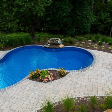 Vinyl pool with Waterfall, Landscape Lighting and Landscaping