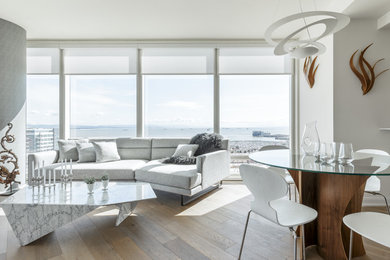 Inspiration for a contemporary open concept medium tone wood floor and brown floor living room remodel in San Francisco with gray walls