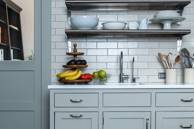 Inspiration for a contemporary kitchen remodel in New York with shaker cabinets, gray cabinets, quartz countertops, white backsplash and subway tile backsplash