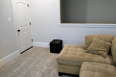 Inspiration for a mid-sized modern enclosed home theater remodel in Houston with a projector screen