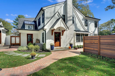 White two-story concrete fiberboard exterior home idea in Other with a mixed material roof