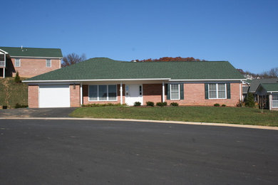 Inspiration for a small one-story brick exterior home remodel in Other