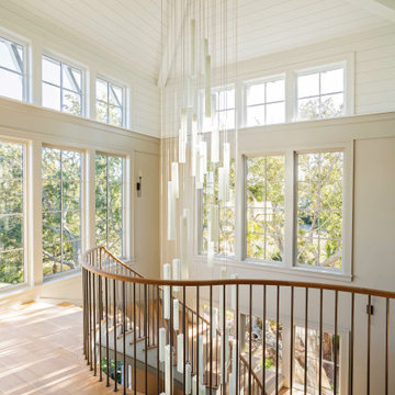 Glass Lighting Defining a Double-Height Stair Hall with cathedral ceiling