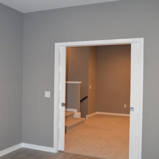 Photo of a medium sized modern study in Other with grey walls, laminate floors and grey floors.