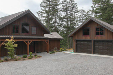 Mid-sized rustic brown one-story wood exterior home idea in Seattle with a metal roof