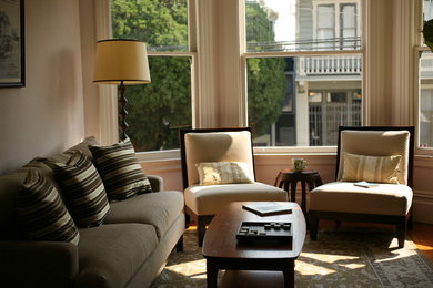 Example of a mid-sized transitional enclosed light wood floor living room design in San Francisco with a standard fireplace, a stone fireplace and beige walls