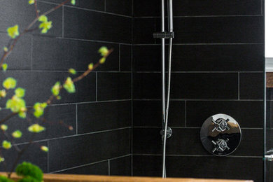 Small urban black tile and porcelain tile porcelain tile bathroom photo in Montreal with a two-piece toilet, white walls and a vessel sink