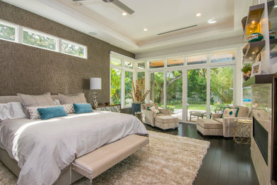 Large trendy master dark wood floor bedroom photo in Orange County with white walls, a ribbon fireplace and a stone fireplace