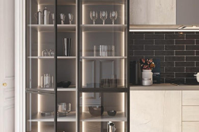 Example of a large minimalist l-shaped eat-in kitchen design in Tampa with flat-panel cabinets
