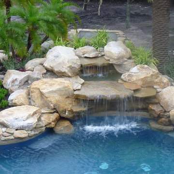 Large rock waterfall into swimming pool