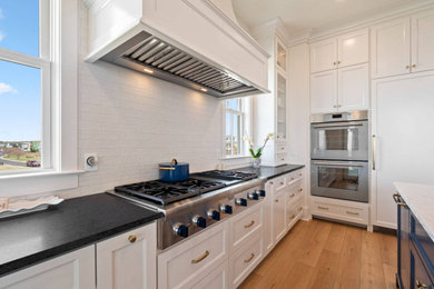 Inspiration for a large coastal eat-in kitchen remodel in Other with flat-panel cabinets, white cabinets and two islands