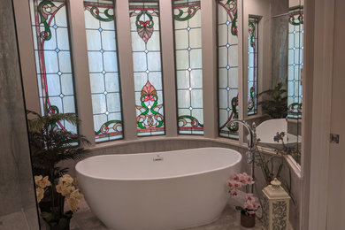 Example of a mid-sized transitional master white tile and porcelain tile ceramic tile, gray floor and double-sink bathroom design in Houston with shaker cabinets, gray cabinets, gray walls, an undermount sink, quartz countertops, a hinged shower door, gray countertops and a built-in vanity