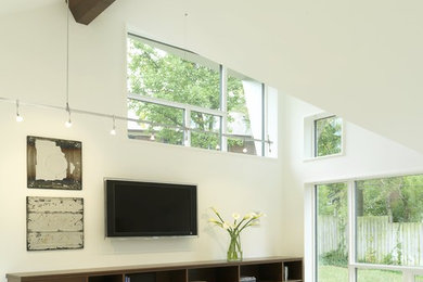 Inspiration for a mid-sized contemporary open concept family room remodel in St Louis with white walls, a wall-mounted tv and no fireplace