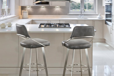 Inspiration for a small modern l-shaped enclosed kitchen remodel in Orlando with flat-panel cabinets, white cabinets, gray backsplash, stainless steel appliances, an island and yellow countertops