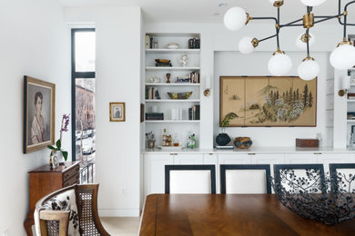 Transitional dining room in New York with white walls.