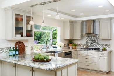 Mid-sized traditional u-shaped kitchen in Orange County with shaker cabinets and white cabinets.