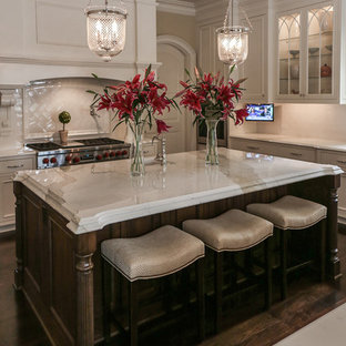 Huge transitional kitchen pantry inspiration - Example of a huge transitional galley dark wood floor and brown floor kitchen pantry design in Charlotte with recessed-panel cabinets, white cabinets, wood countertops, white backsplash, subway tile backsplash, stainless steel appliances, two islands and an undermount sink