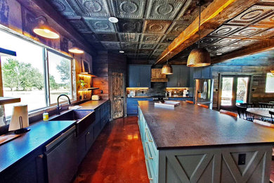 Example of a large cottage l-shaped concrete floor and multicolored floor eat-in kitchen design in Austin with a farmhouse sink, shaker cabinets, blue cabinets, quartz countertops, multicolored backsplash, shiplap backsplash, stainless steel appliances, an island and gray countertops