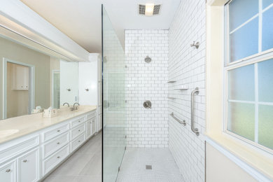 Bathroom - cottage master white tile and porcelain tile double-sink, ceramic tile and white floor bathroom idea in Austin with raised-panel cabinets, white cabinets, beige walls, beige countertops and a built-in vanity
